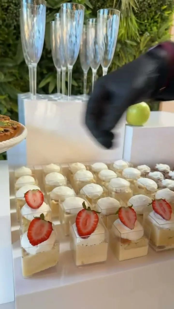 Placing desserts by hand on a dessert table
