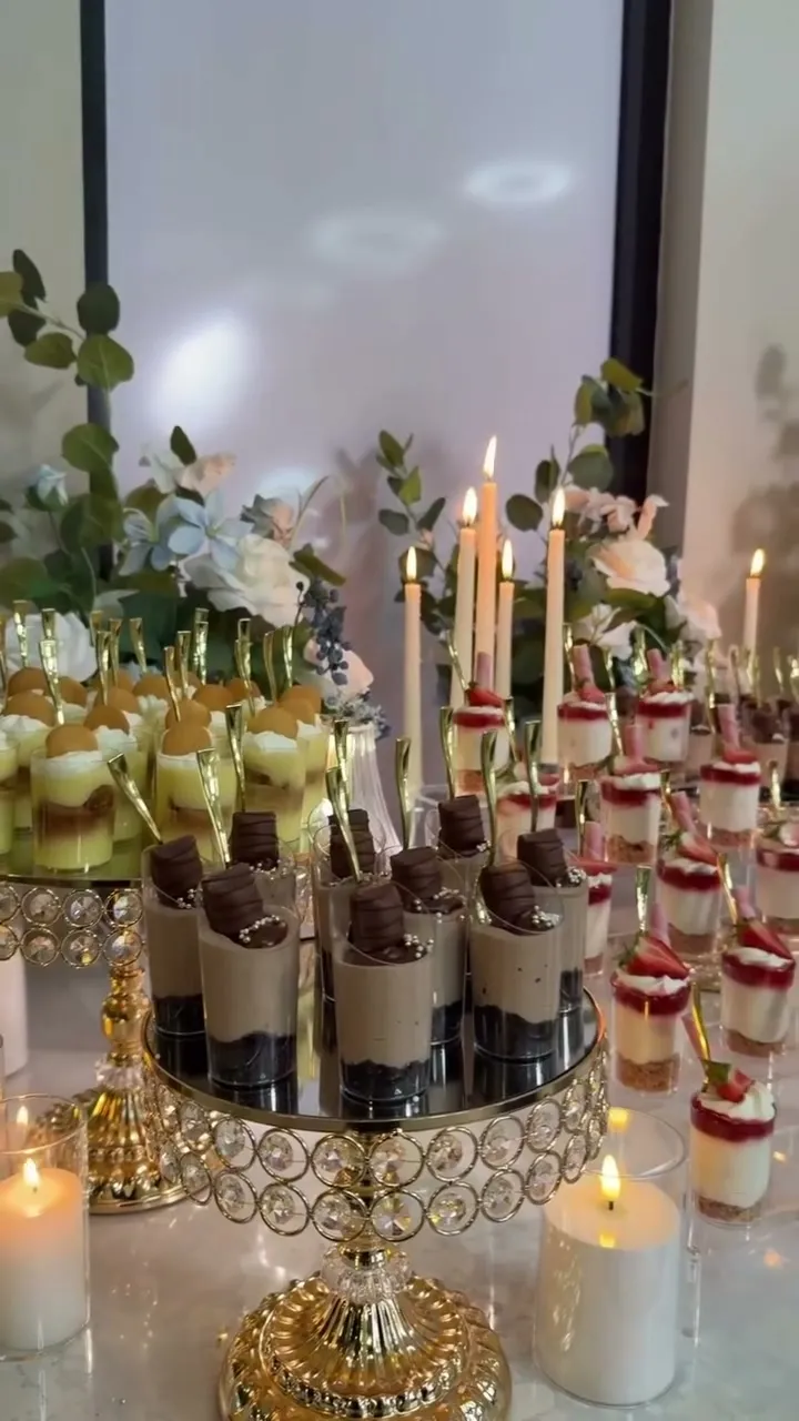 Mousse shooters and dipped pretzels on a gold-accented dessert table