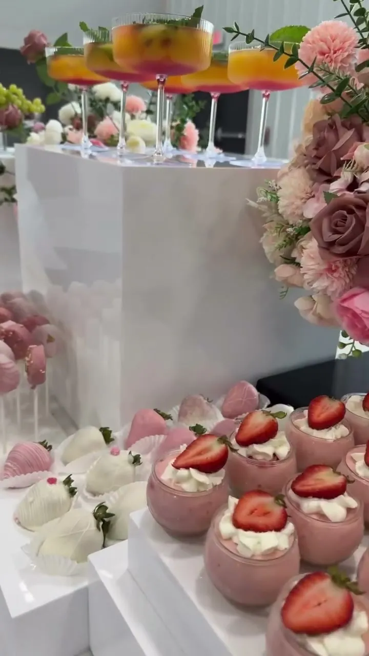 Strawberry mousse cups beside blush roses